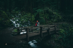 Crtrgrl meditates on a moss covered cascade in the temperate rainforest